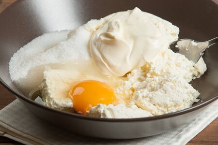 Cooking Process Of Homebaked Cottage Cheese Pie. Raw Ingredients In Bowlの写真素材
