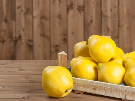 Ripe Quince Fruits In Wooden Boxの写真素材
