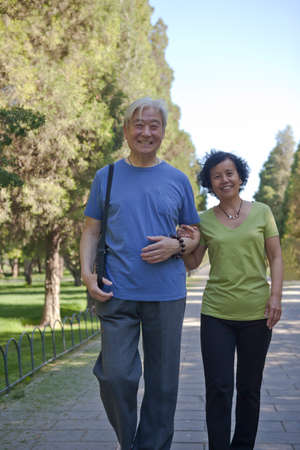 Two old people exercising in the park