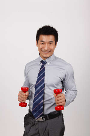 A business man with dumbbellsの写真素材