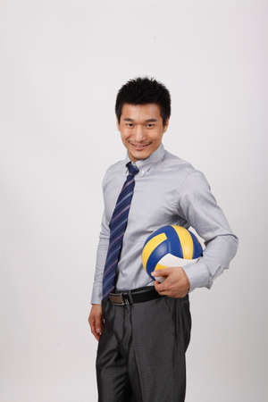 A business man playing volleyballの写真素材