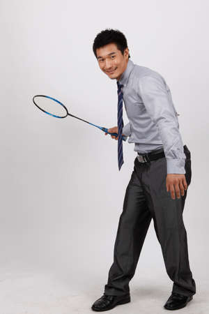 A business man playing badmintonの写真素材