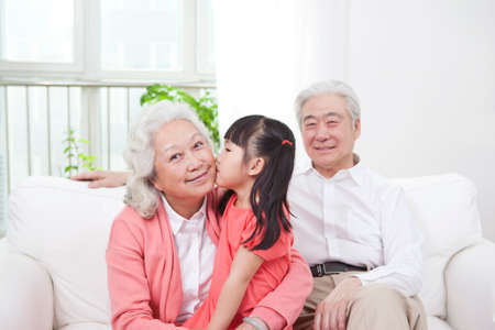 Senior couple with granddaughterの写真素材