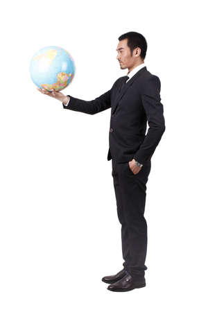 Young businessman holding terrestrial globeの写真素材
