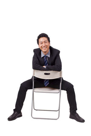 Cheerful businessman sitting postureの写真素材