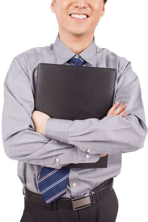 Businessman holding notebook posing in studioの写真素材