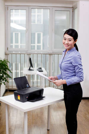 Businesswoman using a printer