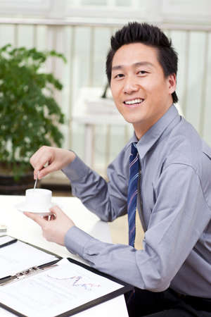 Close-up of a businessman using a laptop in an officeの写真素材