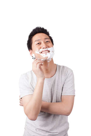 Young man doing shavingの写真素材