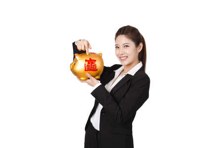 Businesswoman holding a piggy bankの写真素材