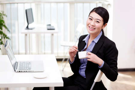 Businesswoman holding a coffee cupの写真素材