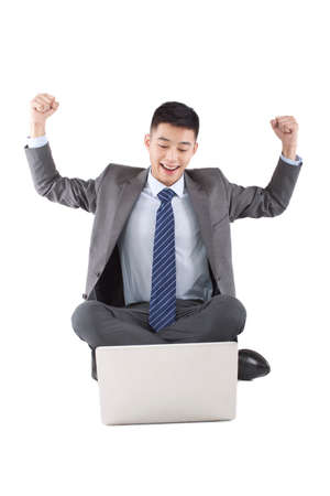 Portrait of a young businessman sitting in the front of the laptopの写真素材