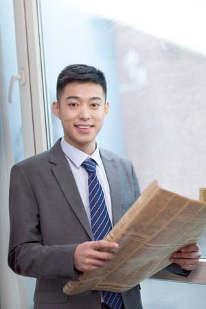 Business businessman holding a newspaper