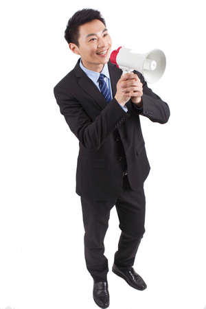 Portrait of young businessman shouting into Megaphone,close-upの写真素材