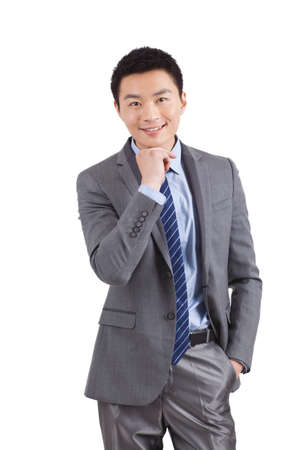 Portrait of young businessman standing in white backgroundの写真素材