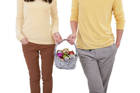 Portrait of a young couple holding gift basket