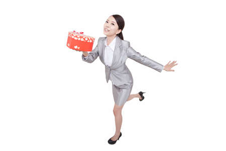 Portrait of young businesswoman holding gift boxの写真素材