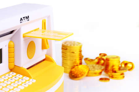 ATM and coins plastic toy on white backgroundの写真素材