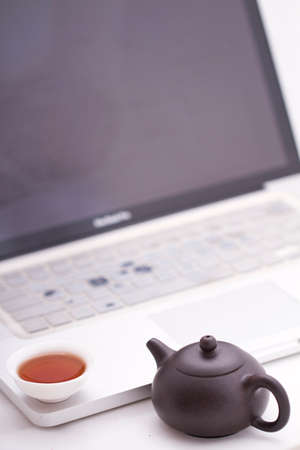 A cup of tea with the computerの写真素材