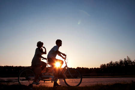 The young couple riding a bicycleの写真素材
