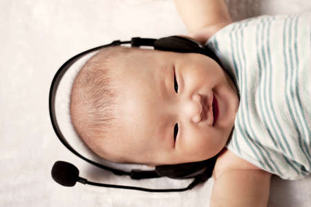 A baby wearing a headsetの写真素材