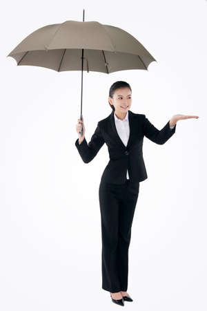 Oriental fashion business woman holding an umbrellaの写真素材