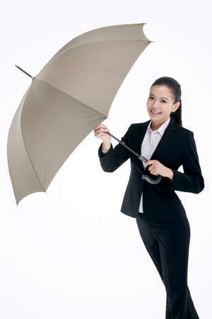 Oriental fashion business woman holding an umbrellaの写真素材