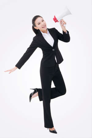 Oriental business woman using a loud speakerの写真素材