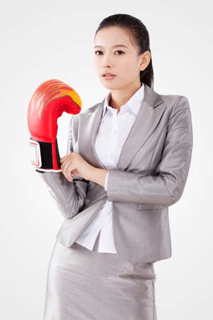Business woman wearing boxing glovesの写真素材