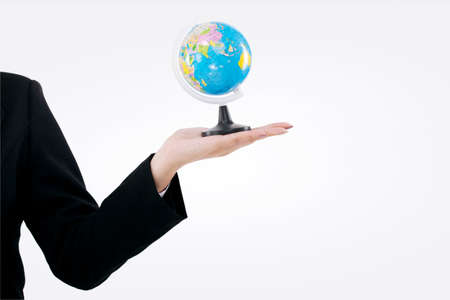 Hand holding a globe by business ladyの写真素材