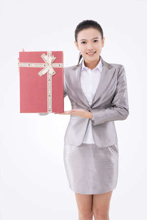 Oriental business woman with gift boxの写真素材