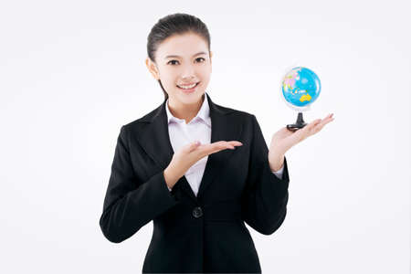 Hand holding a globe business ladyの写真素材
