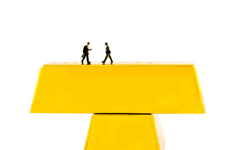 Business people walking in the golden barsの写真素材