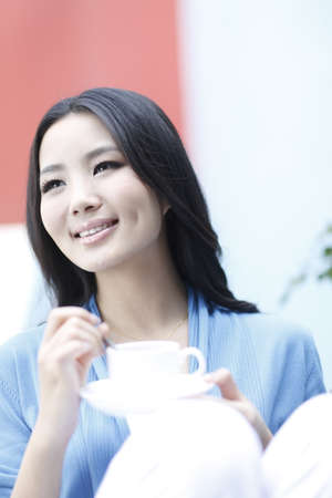 Fashion young woman drinking coffeeの写真素材