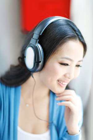 Fashion young woman wearing headset, listen to musicの写真素材