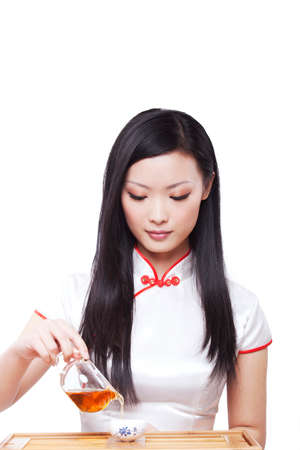 cheongsam Oriental young woman in the preparation of teaの写真素材