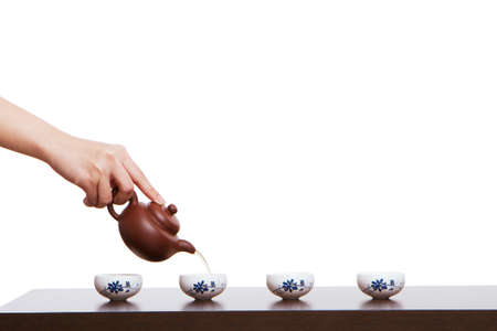 A hand in pouring tea closeupの写真素材