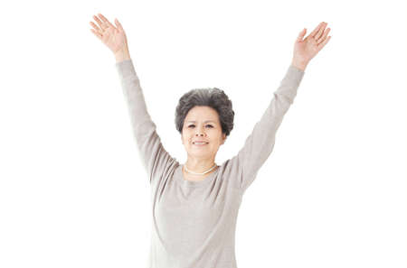 The old woman raise her arms up