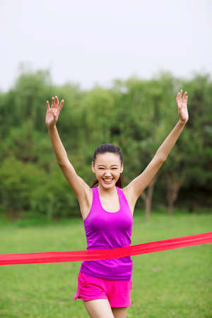 Young women to cross the finish lineの写真素材