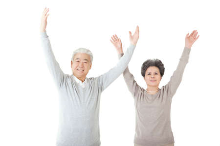 Oriental old couple with arms upraised