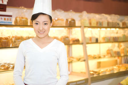 The happy bakery saleswoman is in the bakeryの写真素材