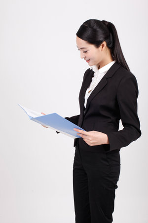 A business woman holding a blue folder high quality photoの写真素材