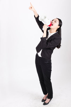A young business woman holding a megaphone high quality photoの写真素材