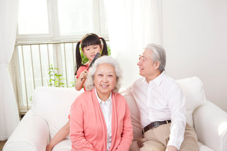 Happy grandparents and grandchildren are playing in the living room high quality photoの写真素材