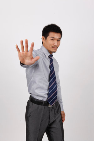 A young business man gesturing in a shirt high quality photoの写真素材