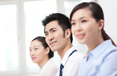 Group of business people sitting at conference table high quality photoの写真素材