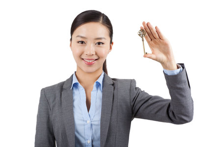 Portrait of a Young woman holding key high quality photoの写真素材