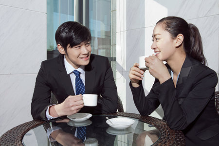 Business man and business woman discussing in office high quality photoの写真素材