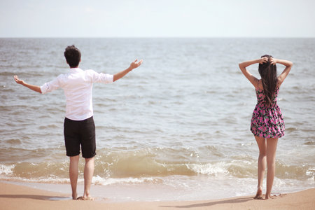 Portrait of a Couple standing on seaside high quality photoの写真素材