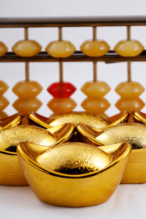 A gold ingot and abacus closeup high quality photoの写真素材